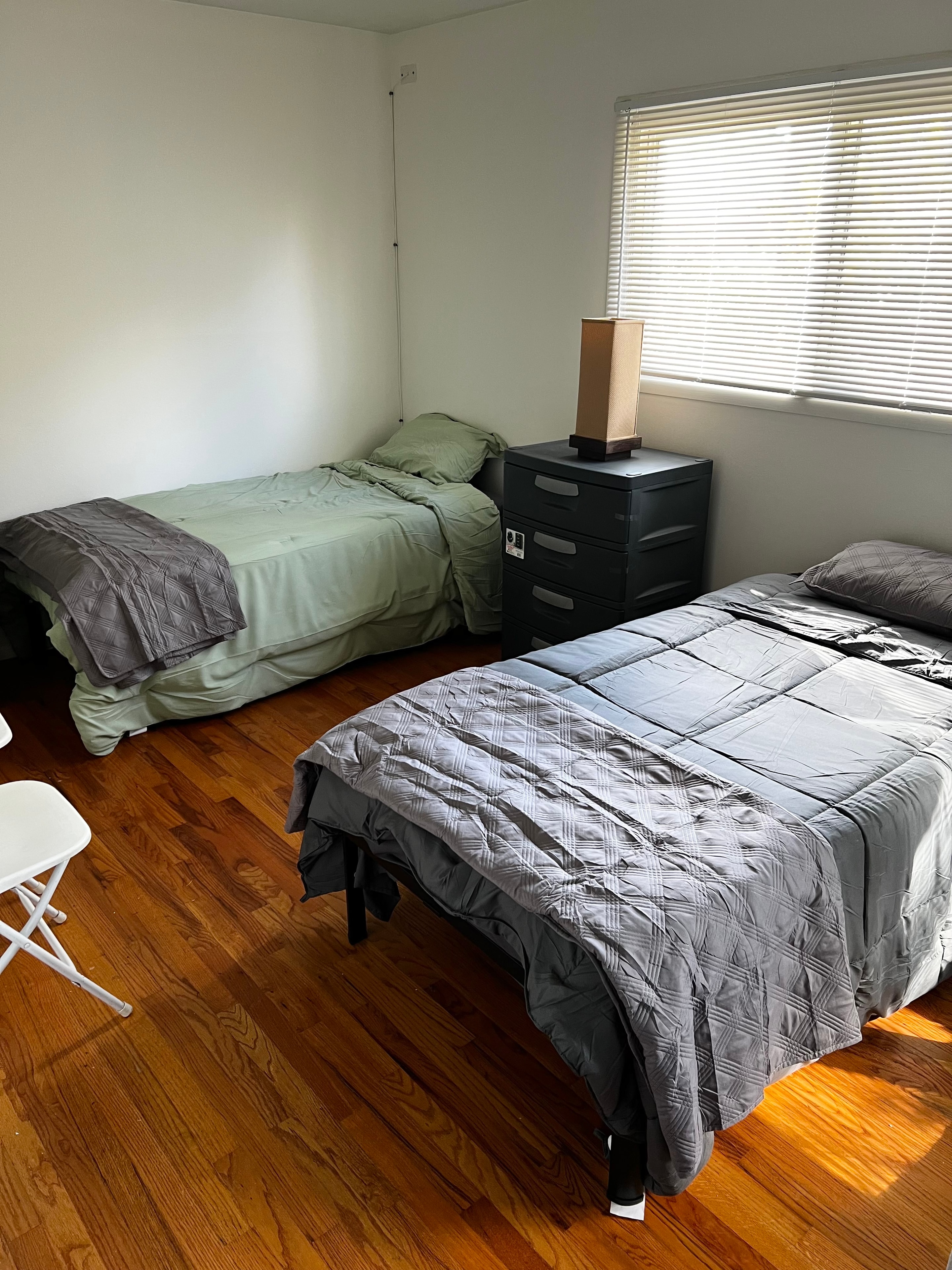Resident bedroom with beds and natural light