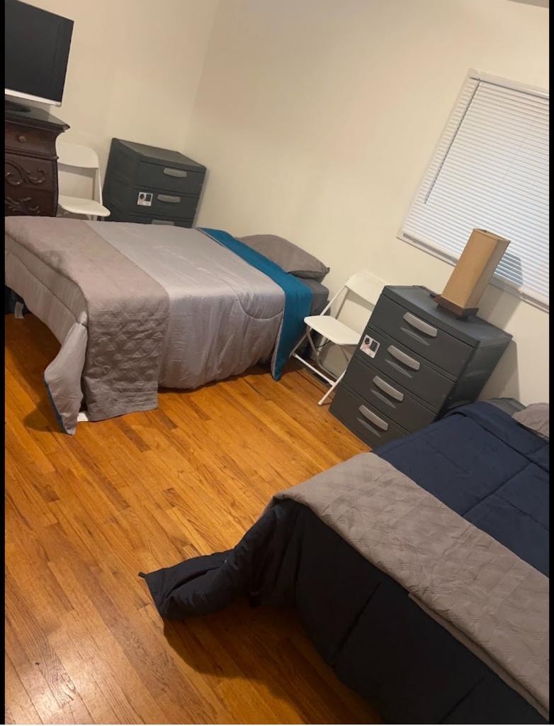 Master bedroom with warm hardwood floors